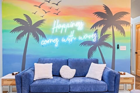 Happiness Comes in Waves — our signature mural sets the tone for the whole trip. You can't be stressed in this room.
