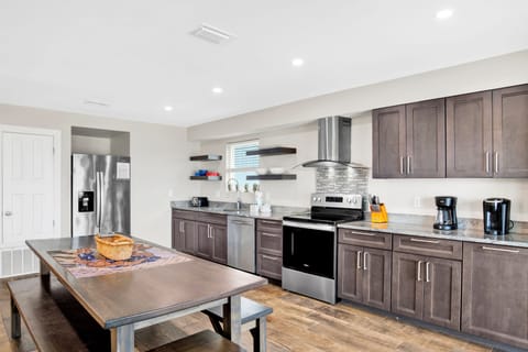 The kitchen features stainless appliances and stone counters