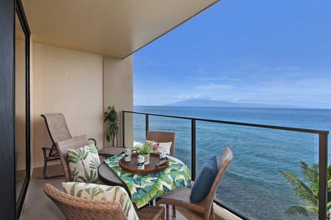 Enjoy your meals with breathtaking views of the Pacific from this private balcony dining setup