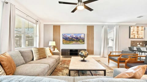 Generously sized living room featuring a cozy sofa, creating an inviting and comfortable space ideal for cherished family reunions and quality time together.