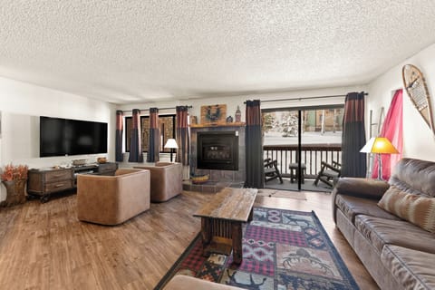 Cozy up by your crackling fireplace while snow blankets the view outside your balcony—perfect for après-ski relaxation.
