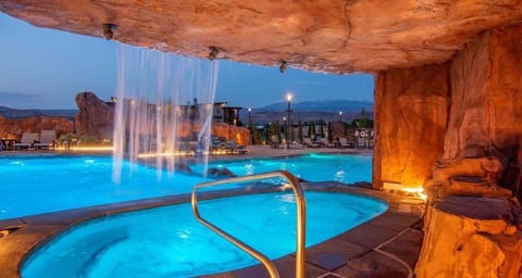 Beautiful grotto hot tub under cascading waterfall