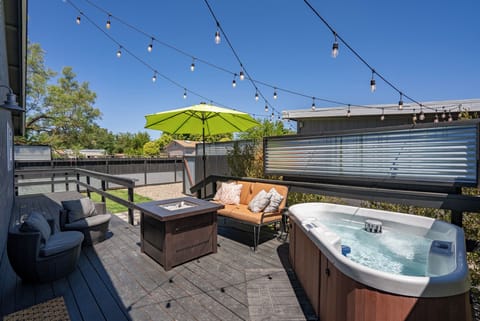 firepit and hot tub on back porch