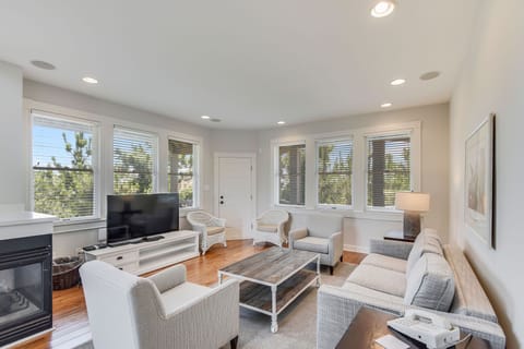 Gather with ease in a sunlit living room where crisp tones, soft textures, and surrounding views create the perfect coastal retreat.