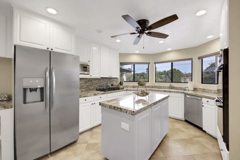 The fully-equipped kitchen features stunning stainless steel appliances.