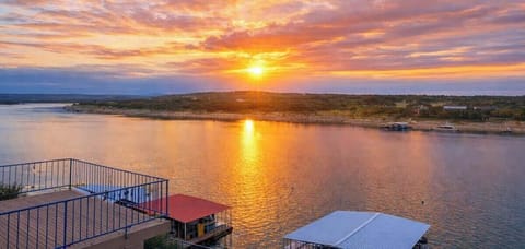 Large waterfront hot spot with easy access to Lake Travis, boatslip and nearby ramp, with pool side lounging, and an outdoor bbq on the deck with this view!