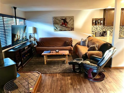 Welcome & inviting main room with large smart TV, futon / comfortable couch.