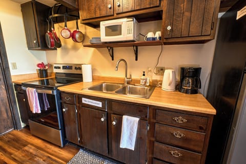 Full Size Kitchen with stove/oven, sink, refrigerator, microwave, and pantry!