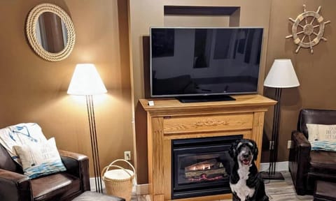 Snuggle up by the glowing fireplace in this inviting living space.