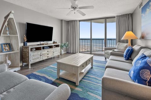 Sectional sofa facing the ocean-view balcony at Ocean Bay Club 604, a 4-bedroom rental from Thomas Beach Vacations
