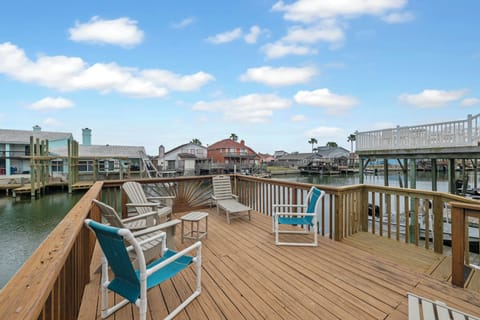 Step onto your private waterfront deck where comfortable seating awaits waterside relaxation. The peaceful canal setting creates the perfect escape.