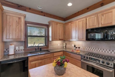 Beautiful granite countertops and a butcher block island.