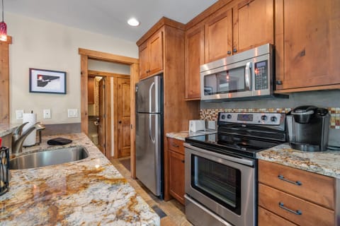 Remodeled kitchen with stainless steel appliances and granite counter tops