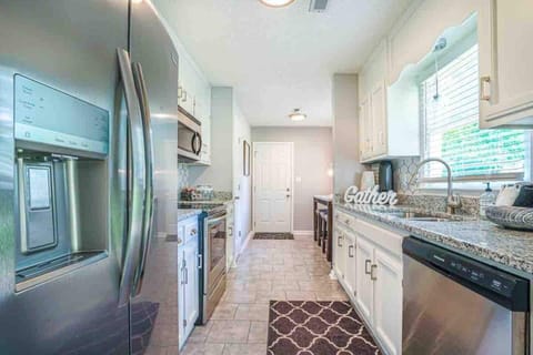 Kitchen with stainless steel appliances. Ice maker with crushed and cubed ice. 