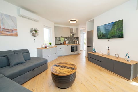 Apartment | Living area | 70-inch Smart TV with satellite channels