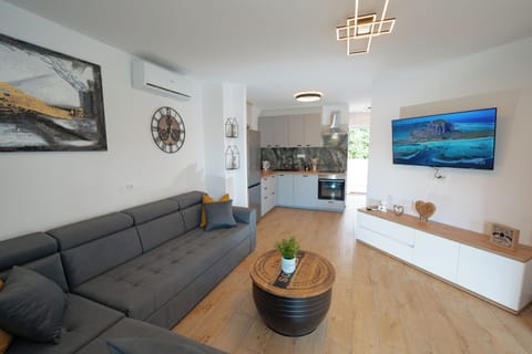 Apartment | Living area | 70-inch Smart TV with satellite channels