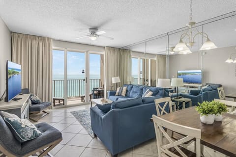 Beautiful, bright, and open living and dining space with tall ceiling, Gulf views, and comfortable seating around a 58" Smart TV for Netflix, Prime TV, etc.