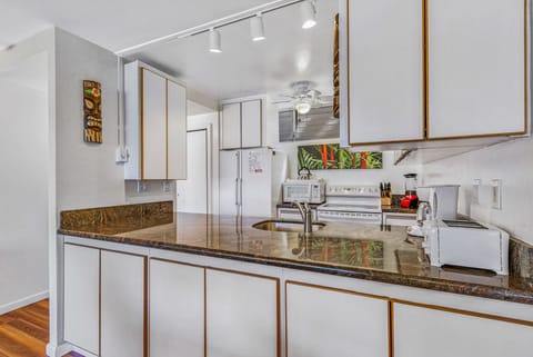 Kitchen view with track lighting, fridge, dishwasher, micro, stove, stacked W/D