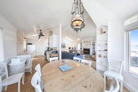 View from the upstairs dining area looking back into the kitchen and living room. Beyond the living room is the hallway which leads to bedrooms/bathrooms.
                