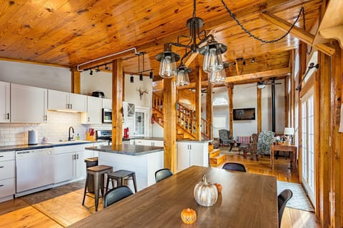 Large kitchen with a table, island seating and bar seating.