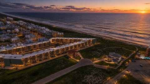 Twilight Aerial — Neighborhood & Beach Home Lit at Sunset