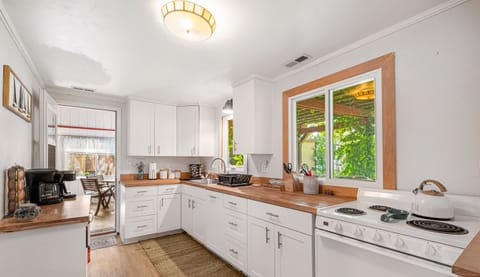 Bright and rustic kitchen with butcher block counters. Fully equipped.