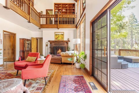 Living area with fireplace, ample seating opens to deck