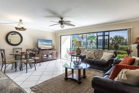 Beautiful living room with wall of sliding doors that open wide to the screened lanai....dock& canal views!