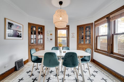 Gather around your elegant dining table beneath a stunning wicker pendant light, where meals become memories.