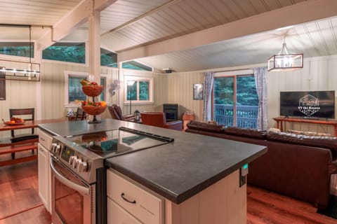 The main kitchen on the second floor includes a dishwasher, oven, stovetop, refrigerator, drip coffee pot, and crock pot. There are 3 stools for counter seating. Cooking tools and diningware are all provided. 