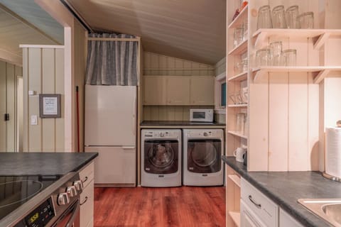 Second floor refrigerator, microwave and laundry area which includes a washer and dryer. An iron and mini ironing board are provided. 