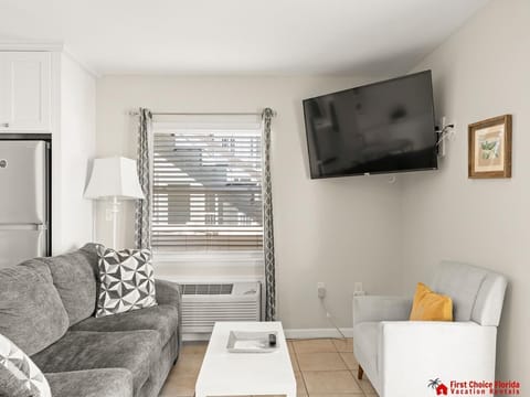 Cozy living room with plush seating and wall-mounted TV