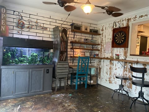 Fish tank, desk, darts, and high top bar stools