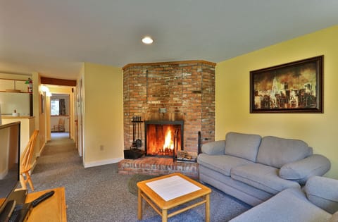 Our cozy one bedroom condo features a homey living area with wood burning fireplace.
