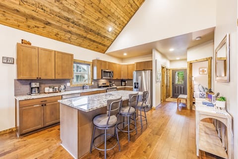 Spacious Kitchen area invites you in with sleek finishes with two door refrigerator and rustic elegance.