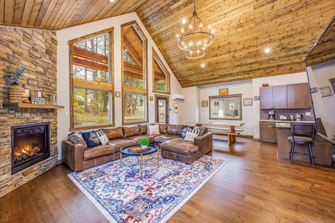 High Ceiling Great room with Floor to Ceiling Stone Indoor Gas Fireplace