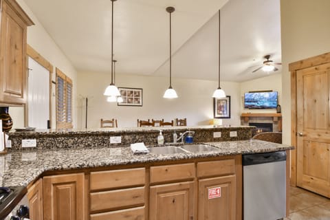 Fully equipped kitchen with granite countertops, stainless steel appliances, and plenty of prep space—perfect for cooking meals for the whole family.
