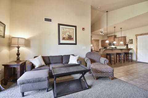 Comfortable living room with a plush couch, chaise chair, and coffee table. A great space to unwind, watch TV, or gather with family and friends.