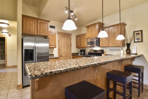 Spacious kitchen with granite counters, stainless appliances, and all essentials to prepare meals for the whole family.