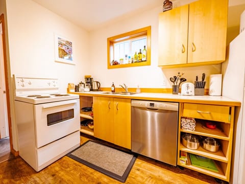 Fully stocked kitchen with stove, dishwasher, fridge, and microwave.