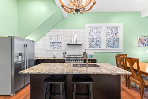 Large granite topped kitchen island and pull out trash.