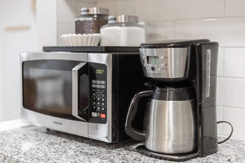 - Morning right with a convenient coffee maker, filters, and microwave at the ready
- Thoughtfully stocked with canisters, utensils, & everything you need to brew or reheat
- Sleek stainless finishes & granite countertops keep the space clean & styli