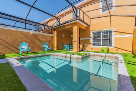 Step into your private oasis, complete with a sparkling pool surrounded by lush artificial grass and inviting turquoise loungers. The screened enclosure lets you enjoy sun-soaked afternoons in comfort and privacy.