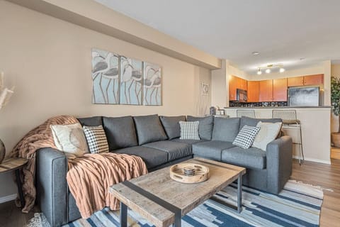 Living room with a Smart TV, board games, a cozy sectional with a pull-out sleeper sofa with all linens provided, and walkout access to the ground-floor patio.