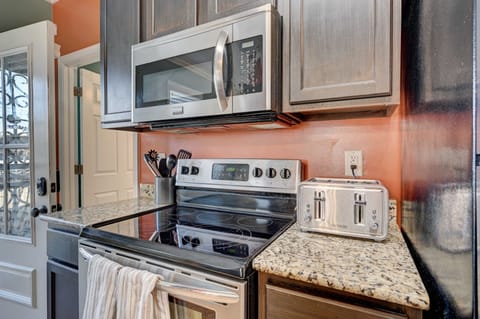 Kitchen including oven/stove, fridge/freezer, and microwave.