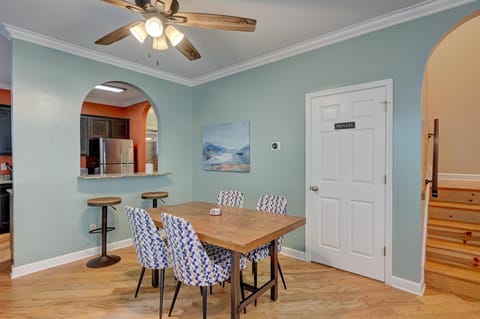 Dining area with barstools overlooking kitchen.