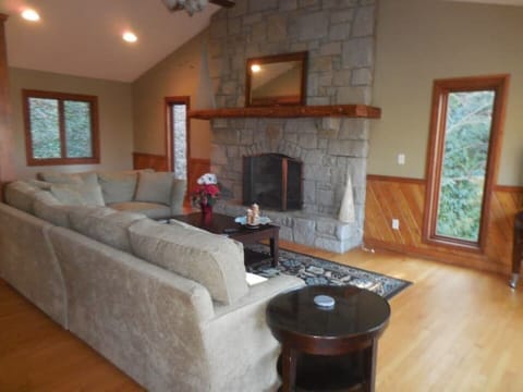 Living room with vaulted ceilings and stone gas fireplace. 