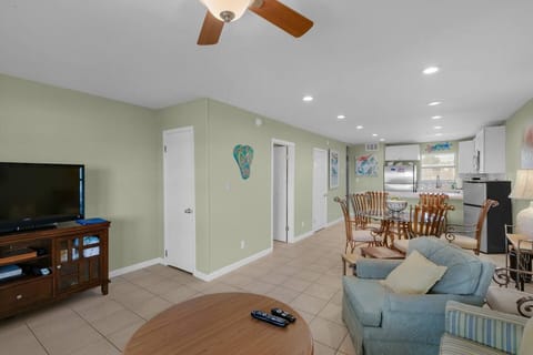 Open living, dining, and kitchen space with half bath