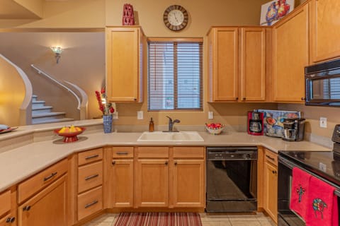 Window in the kitchen overlooks the front porch and adds natural light to work spaces.