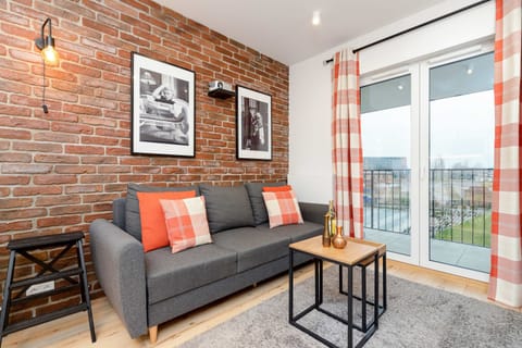 Cozy living room with double sofa bed, TV and access to the balcony.